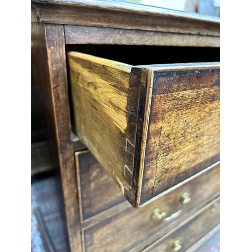 41 - A George III oak and mahogany crossbanded chest of two short over three long drawers with bracket su... 