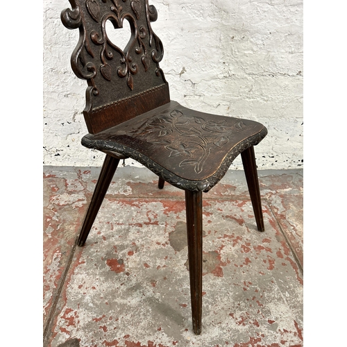 42 - A carved oak hall chair - approx. 84cm high x 39cm wide x 48cm deep