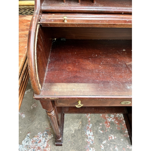 43 - A mahogany roll top bureau