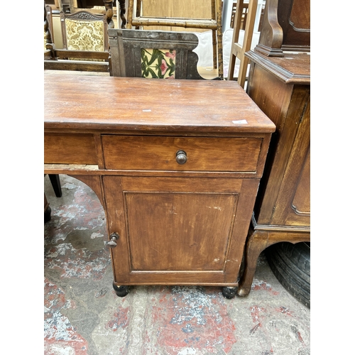 53 - A late 19th/early 20th century stained pine pedestal desk - approx. 78cm high x 146cm wide x 55cm de... 