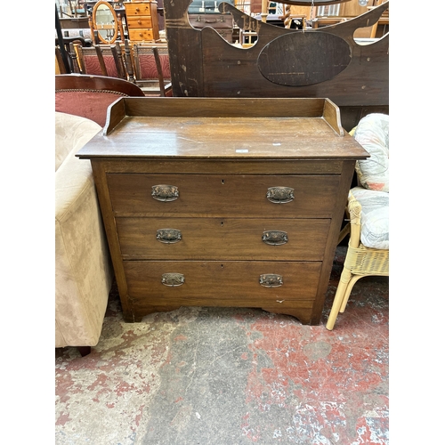 58 - An Edwardian oak chest of three drawers