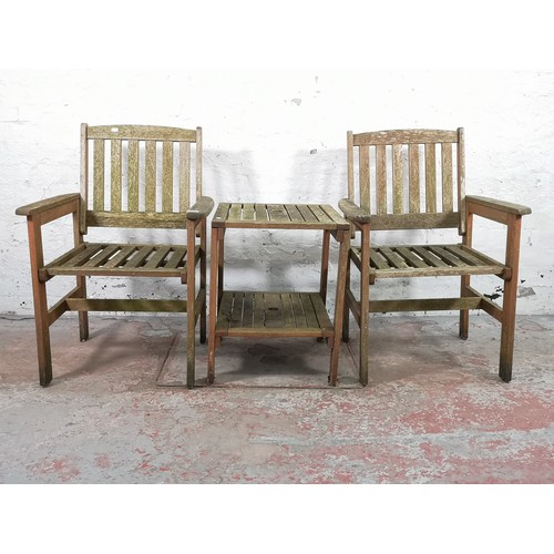 812 - Three pieces of teak garden furniture, two armchairs and one side table