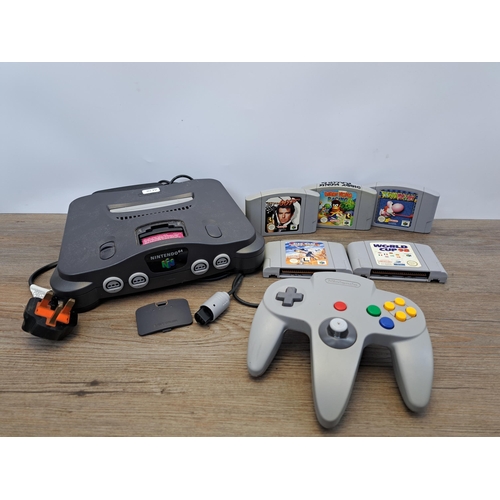 675 - A Nintendo 64 console with five games, controller and memory expansion