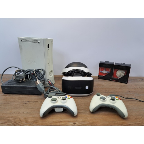 679 - A box containing Microsoft Xbox 360 console with two controllers and cables, Sony PSVR headset and t... 