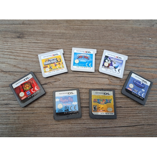 680 - A cased metallic blue Nintendo DSi console and games to include New Super Mario Bros 2, Mario Party ... 