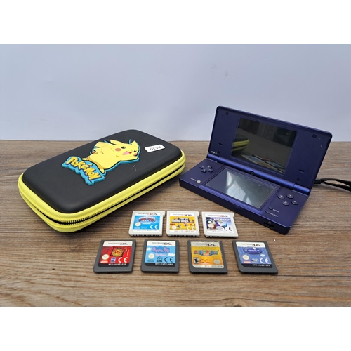 680 - A cased metallic blue Nintendo DSi console and games to include New Super Mario Bros 2, Mario Party ... 