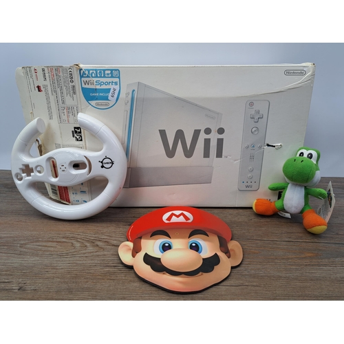 682 - A boxed Nintendo Wii console with games and accessories