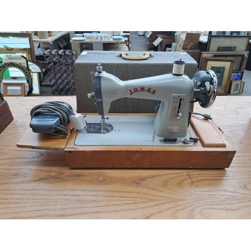 689 - A vintage Jones CBD sewing machine with foot pedal