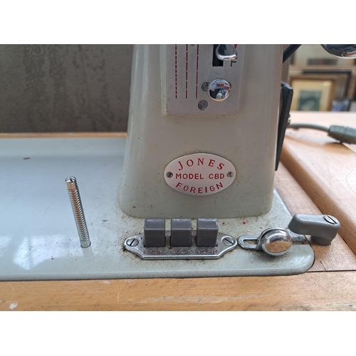 689 - A vintage Jones CBD sewing machine with foot pedal