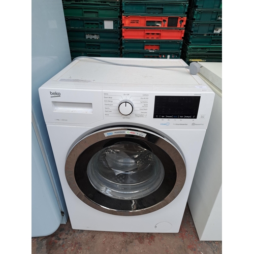 717 - A Beko undercounter washing machine - approx. 84cm high x 59cm wide x 57cm deep