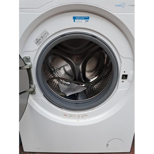 717 - A Beko undercounter washing machine - approx. 84cm high x 59cm wide x 57cm deep