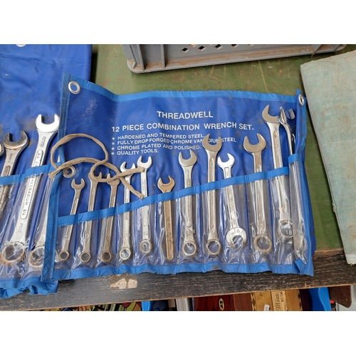 783 - A collection of tools to include three large spanner sets, cased drill bit set, boxed hand riveter s... 