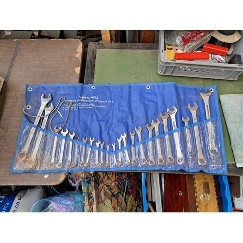 783 - A collection of tools to include three large spanner sets, cased drill bit set, boxed hand riveter s... 