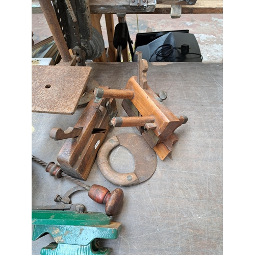 786 - A collection of antique tools to include cast iron drill press, two wood planes etc.