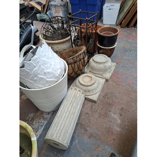 796 - A large collection of garden items to include glazed terracotta planters, hanging baskets, Moroccan ... 