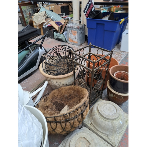 796 - A large collection of garden items to include glazed terracotta planters, hanging baskets, Moroccan ... 