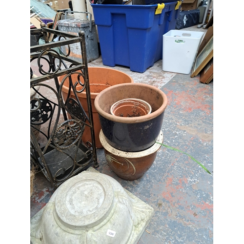 796 - A large collection of garden items to include glazed terracotta planters, hanging baskets, Moroccan ... 