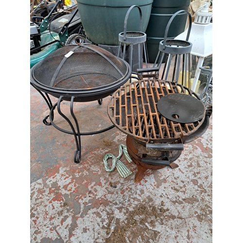 797 - A collection of garden items to include two cast and wrought iron fire pits, pair of wrought iron ha... 