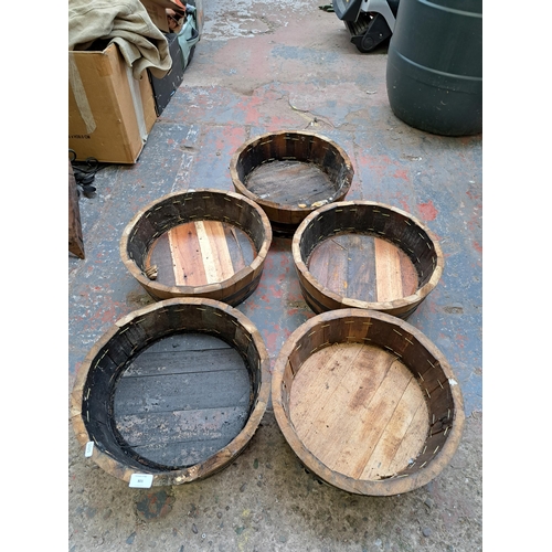 801 - Five wooden and metal banded barrel planters