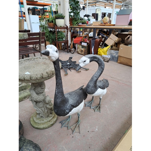 806 - A collection of garden items, pair of painted metal swan figurines, cast stone pedestal bird bath in... 