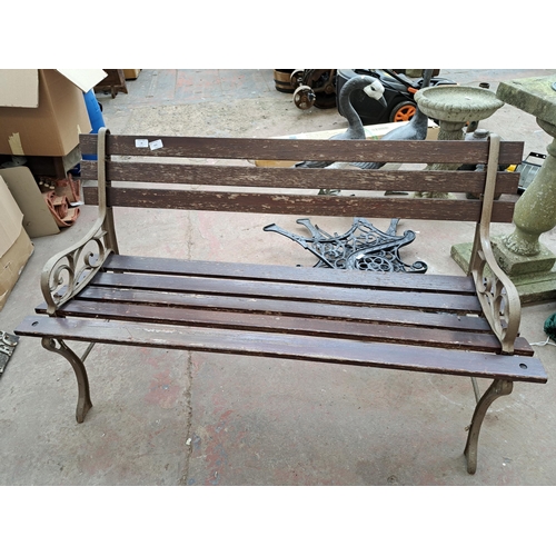 810 - A cast iron and wooden slatted garden bench