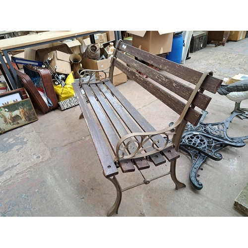 810 - A cast iron and wooden slatted garden bench