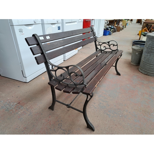 811 - A cast iron and wooden slatted garden bench