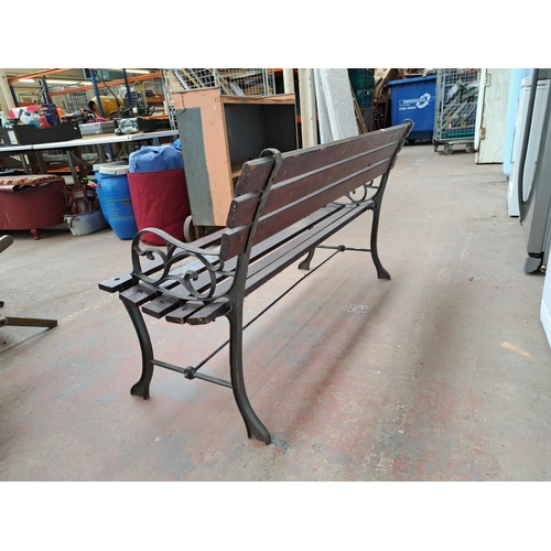 811 - A cast iron and wooden slatted garden bench