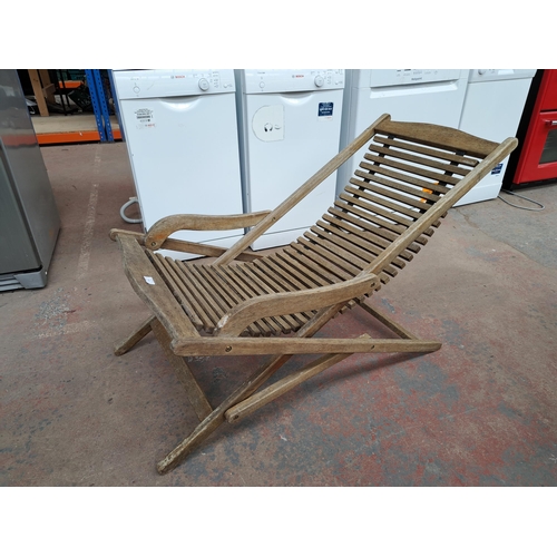 813 - A teak folding sun lounger with hammock base