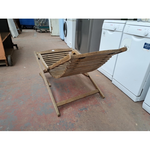 813 - A teak folding sun lounger with hammock base