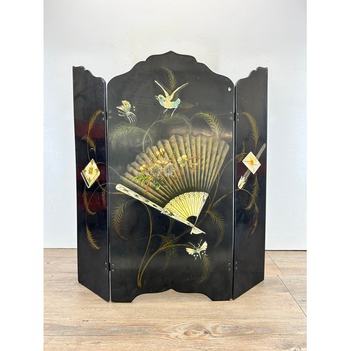 511 - An early 20th century Oriental black lacquered and hand painted three section folding fire screen - ... 