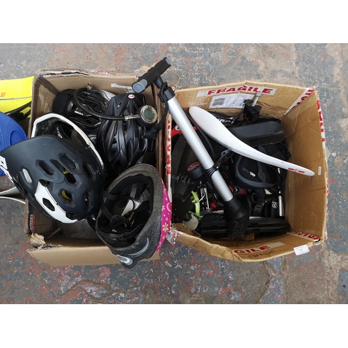 747 - Two boxes containing cycling equipment to include helmets, mud guards, pumps etc.