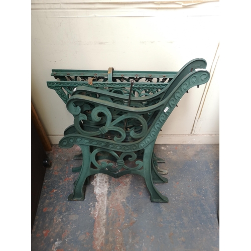 753 - Two 19th century style cast iron items, one pair of bench ends and one pair of table ends