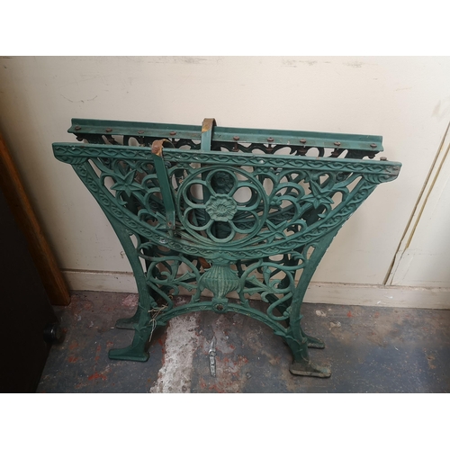 753 - Two 19th century style cast iron items, one pair of bench ends and one pair of table ends