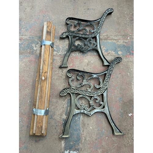 754 - A pair of 19th century style cast iron garden bench ends with wooden slats