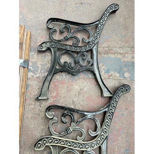 754 - A pair of 19th century style cast iron garden bench ends with wooden slats