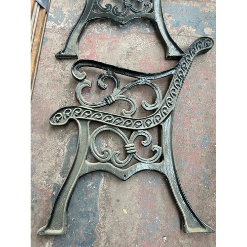 754 - A pair of 19th century style cast iron garden bench ends with wooden slats