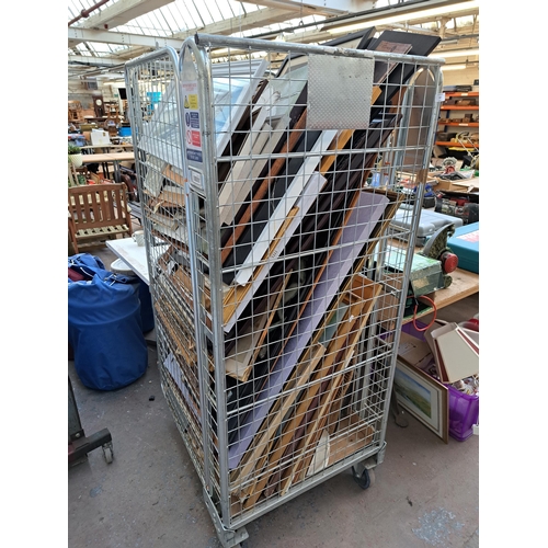 817 - A cage containing a large collection of framed pictures and mirrors - cage not included