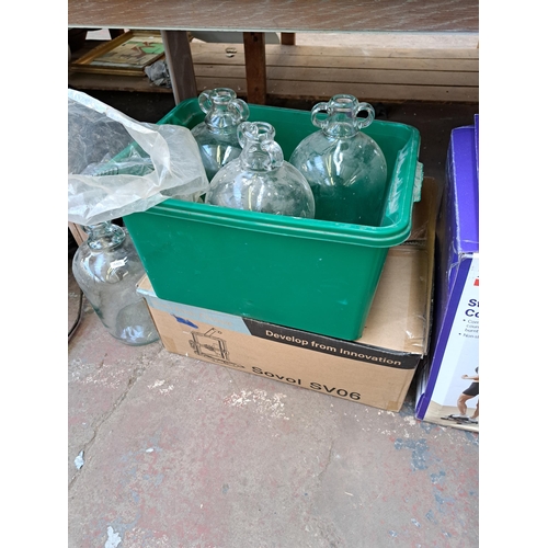 820 - Five boxes containing vintage glass demijohns, clothing, sack trucks, leather horse riding saddle et... 