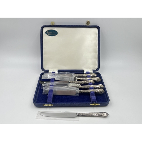 2302A - A cased set of six stainless steel butter knives with hallmarked sterling silver handles