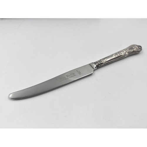 2302A - A cased set of six stainless steel butter knives with hallmarked sterling silver handles