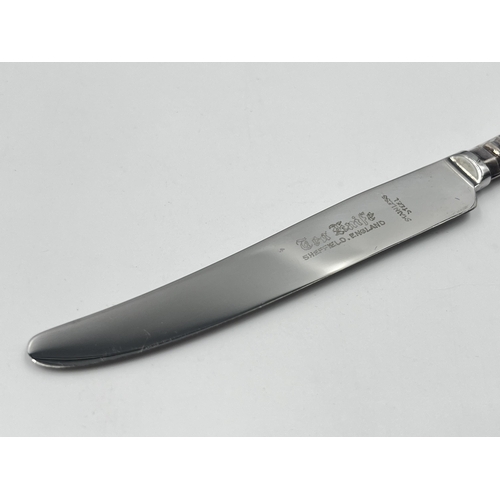 2302A - A cased set of six stainless steel butter knives with hallmarked sterling silver handles