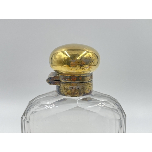 2304 - A hallmarked London silver and glass hip flask with hallmarked London silver removable cup, dated 19... 