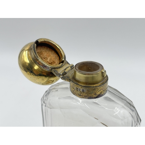 2304 - A hallmarked London silver and glass hip flask with hallmarked London silver removable cup, dated 19... 