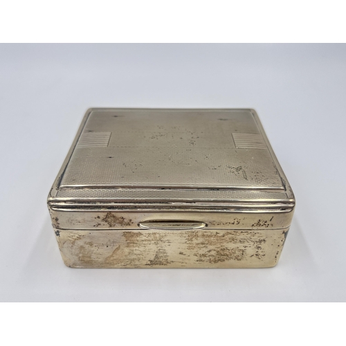 2304A - An Art Deco hallmarked Birmingham silver cigarette box with wooden lining, dated 1938 - approx. gros... 