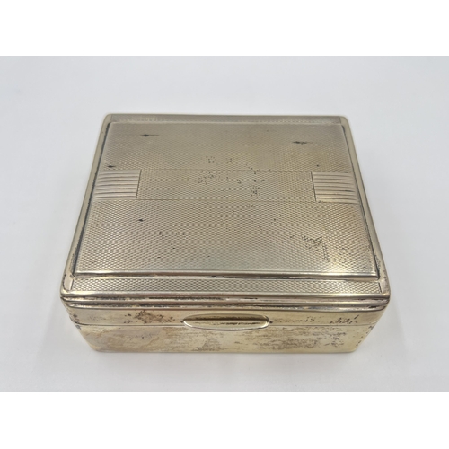 2304A - An Art Deco hallmarked Birmingham silver cigarette box with wooden lining, dated 1938 - approx. gros... 