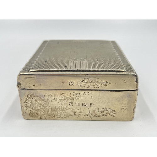 2304A - An Art Deco hallmarked Birmingham silver cigarette box with wooden lining, dated 1938 - approx. gros... 