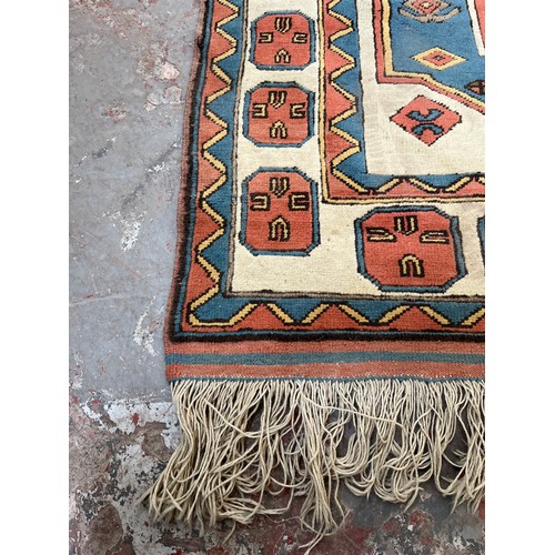 89 - A hand knotted Kazak rug - approx. 230cm x 150cm