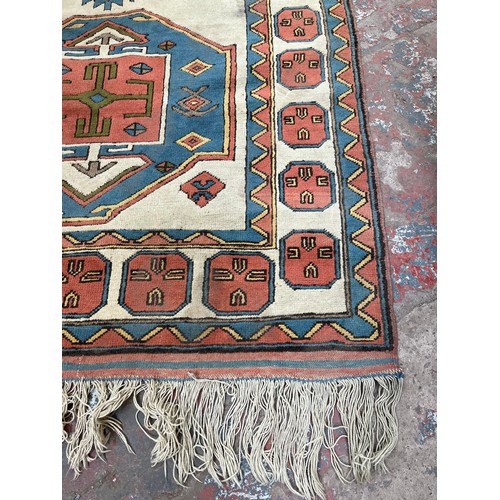 89 - A hand knotted Kazak rug - approx. 230cm x 150cm