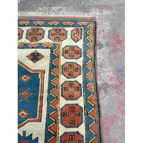 89 - A hand knotted Kazak rug - approx. 230cm x 150cm